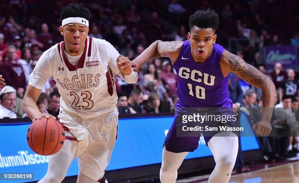 Zach Lofton of the New Mexico State Aggies drives against Damari Milstead of the Grand Canyon Lopes during the championship game of the Western...