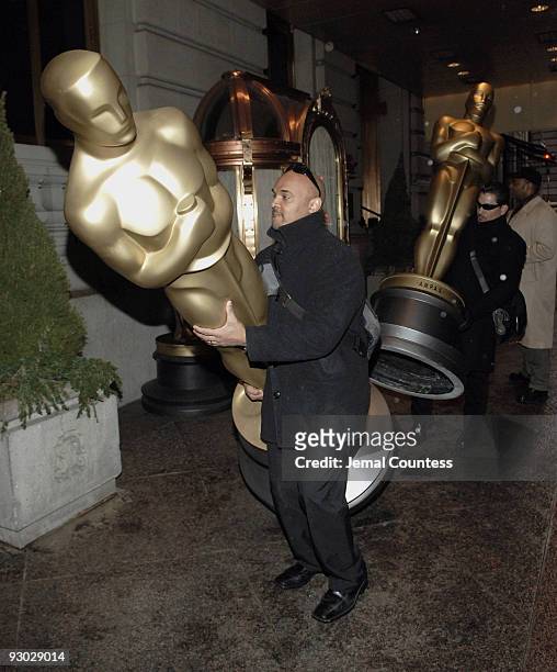 One of the St. Regis Butlers carries an 8 foot Oscar Statue into the St Regis Hotel in preparation for the Official Academy of Motion Picture Arts &...