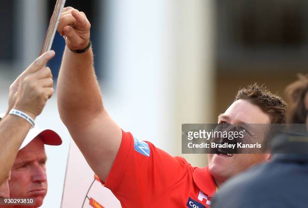 Coach Stuart Dew of the Suns talks tactics at the 3rd quarter time break during the JLT Community Series AFL match between the Gold Coast Suns and...