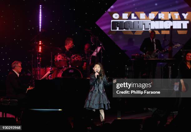 David Foster and Angelica Hale perform onstage at Celebrity Fight Night XXIV on March 10, 2018 in Phoenix, Arizona.