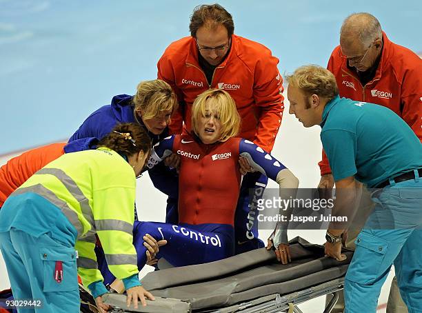 Olympic champion Marianne Timmer Marianne Timmer is helped onto a strectcher by her coach Jack Orie after crashing with Jing Yu of China in the 500m...