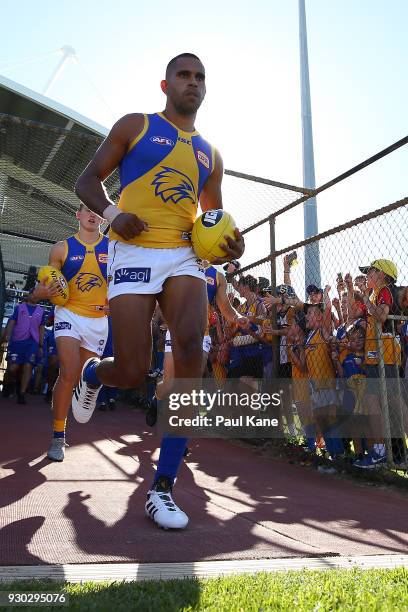 Lewis Jetta of the Eagles runs down the race onto field during the JLT Community Series AFL match between the Fremantle Dockers and the West Coast...