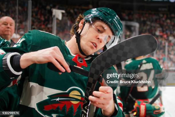 Tyler Ennis of the Minnesota Wild tapes his stick during the game against the Detroit Red Wings at the Xcel Energy Center on March 4, 2018 in St....