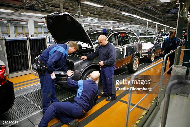 Employees assemble vehicles on the production line at the Volvo factory in Gothenburg, Sweden, on Thursday, Nov. 12, 2009. Volvo AB set aside almost...