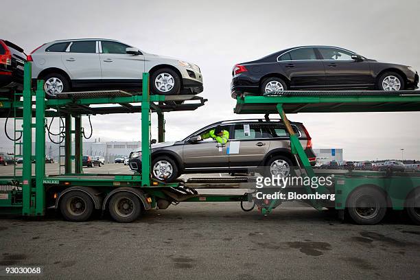 An employee loads Volvo vehicles on to a transporter at the Volvo factory in Gothenburg, Sweden, on Thursday, Nov. 12, 2009. Volvo AB set aside...