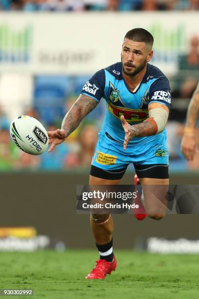 Nathan Peats of the Titans passes during the round one NRL match between the Gold Coast Titans and the Canberra Raiders at Cbus Super Stadium on...