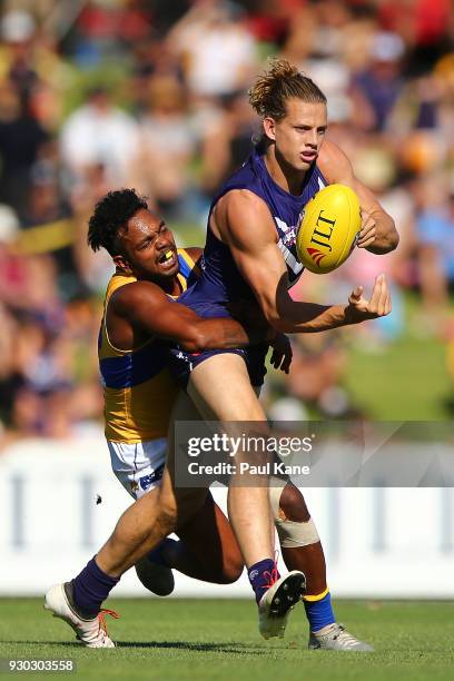 Willie Rioli of the Eagles tackles Nathan Fyfe of the Dockers during the JLT Community Series AFL match between the Fremantle Dockers and the West...