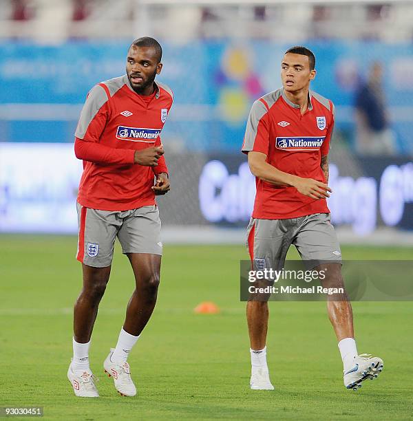 Darren Bent warms up with Jermaine Jenas during the England training session at the Khalifa Stadium on November 13, 2009 in Doha, Qatar.