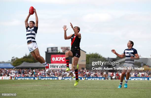 Joel Selwood of the Cats marks the ball ahead of Joe Daniher of the Bombers during the AFL 2018 JLT Community Series match between the Geelong Cats...