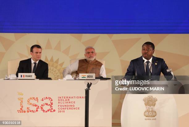 Togo's President Faure Gnassimbe delivers his speech next to French President Emmanuel Macron and Indian Prime Minister Narendra Modi during the...