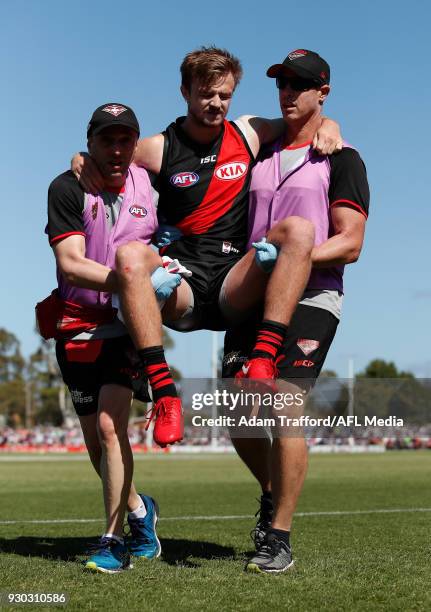 Martin Gleeson of the Bombers is carried off the ground injured during the AFL 2018 JLT Community Series match between the Geelong Cats and the...