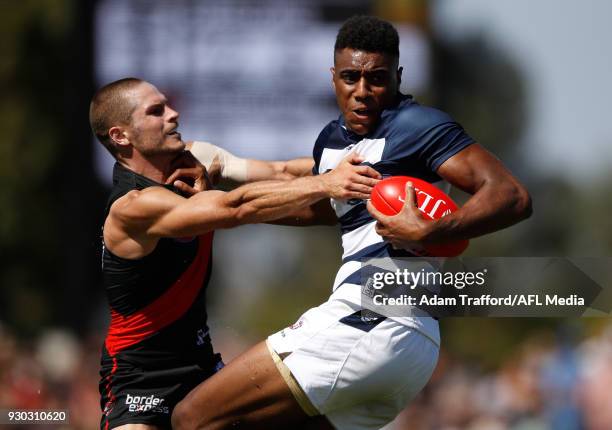 Esava Ratugolea of the Cats is tackled by David Zaharakis of the Bombers during the AFL 2018 JLT Community Series match between the Geelong Cats and...