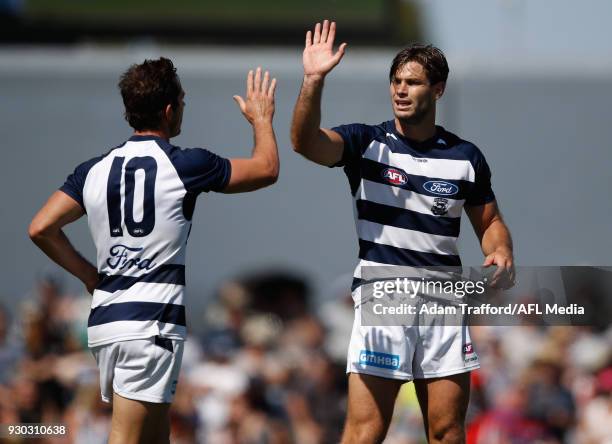 Tom Hawkins of the Cats celebrates a goal with Daniel Menzel of the Cats during the AFL 2018 JLT Community Series match between the Geelong Cats and...