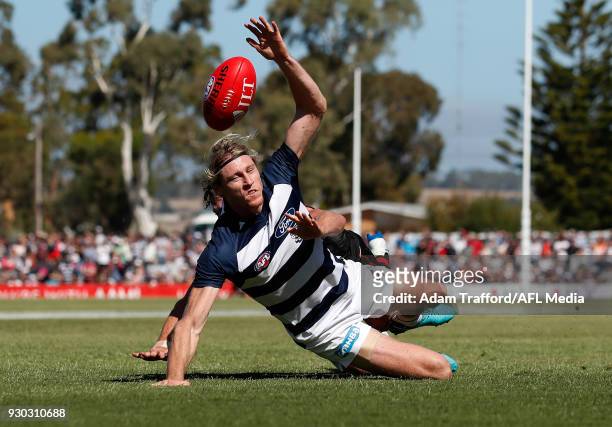 Patrick Ambrose of the Bombers and Mark Blicavs of the Cats compete for the ball during the AFL 2018 JLT Community Series match between the Geelong...