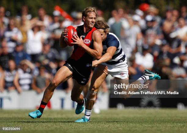 Darcy Parish of the Bombers in action ahead of Jake Kolodjashnij of the Cats during the AFL 2018 JLT Community Series match between the Geelong Cats...