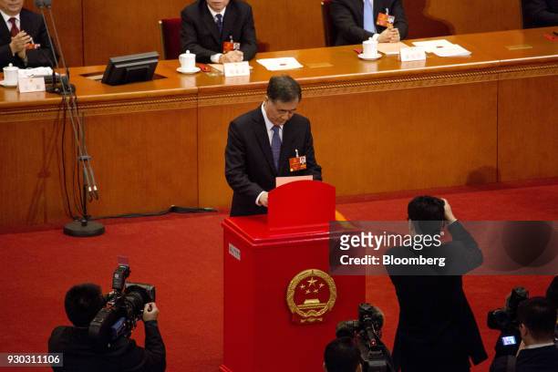 Wang Yang, vice premier, casts his ballot during a vote to repeal presidential term limits at a session at the first session of the 13th National...