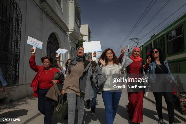 Women chants slogans and raise palcards wich read in Arabic 'In the name of love and in the name of roses, we want equality in the inheritance...