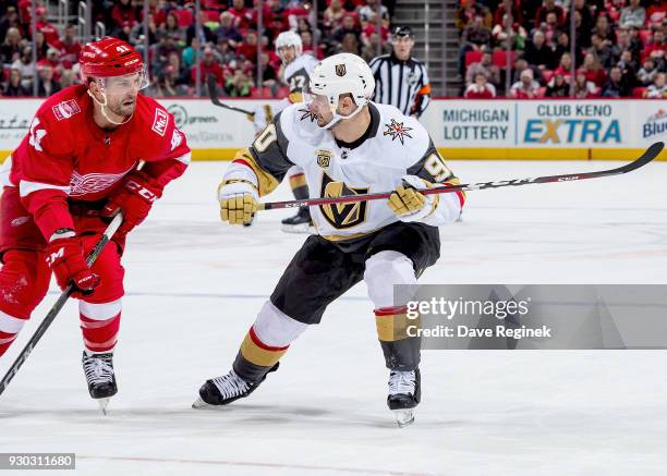 Tomas Tatar of the Vegas Golden Knights skates up ice next to Luke Glendening of the Detroit Red Wings during an NHL game at Little Caesars Arena on...