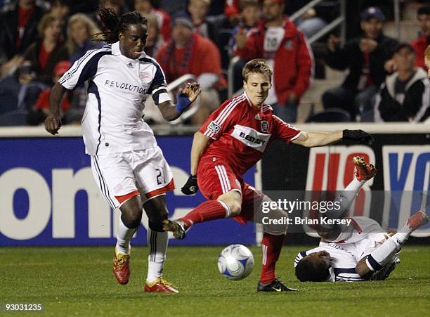 Chris Rolfe of the Chicago Fire and Shalrie Joseph of the New England Revolution go for the ball during the second half of game 2 of the Eastern...