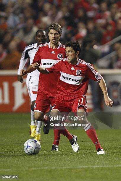 John Thorrington and Logan Pause of the Chicago Fire move the ball up the field against the New England Revolution during the second half of game 2...