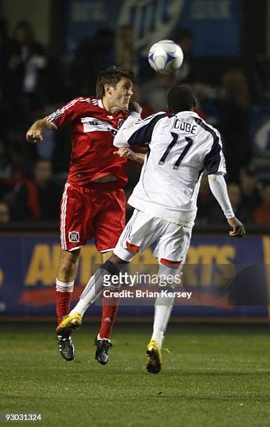 Brandon Prideaux of the Chicago Fire and Kheli Dube of the New England Revolution go up for a header during the second half of game 2 of the Eastern...