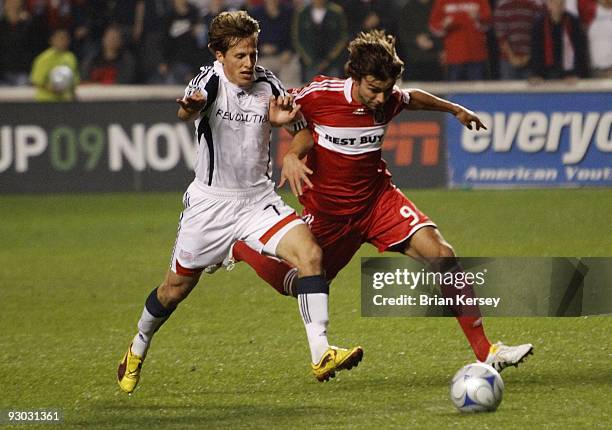 Baggio Husidic of the Chicago Fire and Wells Thompson of the New England Revolution go for the ball during the second half of game 2 of the Eastern...