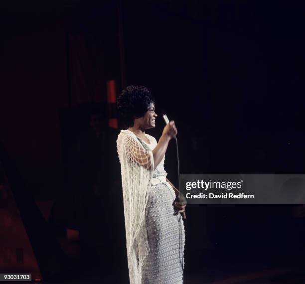 American singer and actress Eartha Kitt performs on stage circa 1970.