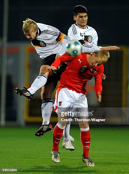 Patrick Funk and Taner Yalcin of Germany battle for the ball with Thomas Hopper of Austria during the U20 International Friendly match between...