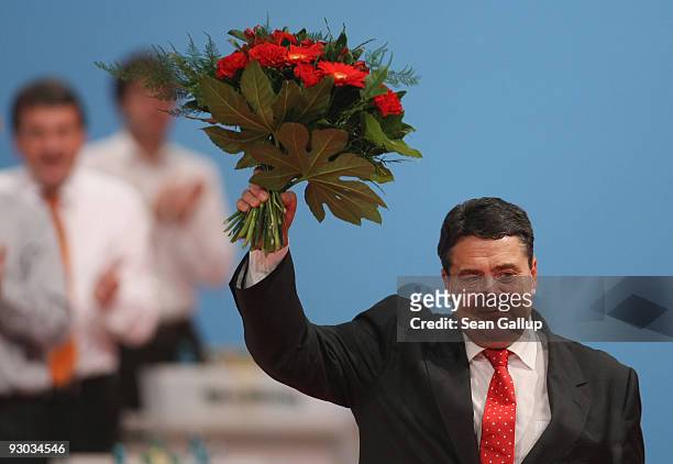 Sigmar Gabriel holds up flowers after being elected new Chairman of the German Social Democratic Party at the SPD party congress on November 13, 2009...