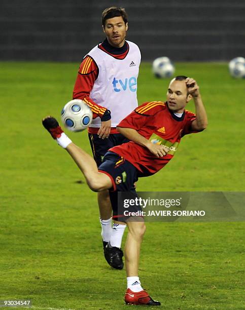 Spain's Andres Iniesta and Xabi Alonso take part in a training session at the Vicente Calderon stadium in Madrid on November 13, 2009. Spain will...
