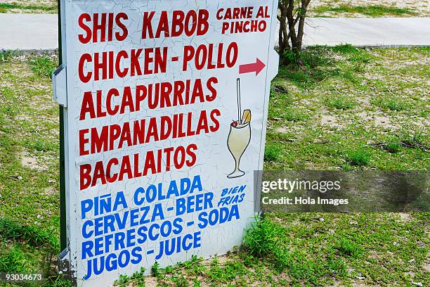 information board on the beach, luquillo beach, puerto rico - luquillo stock-fotos und bilder