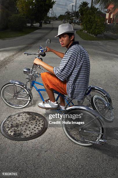 portrait of a teenage boy cycling on a low rider bicycle - low rider bildbanksfoton och bilder