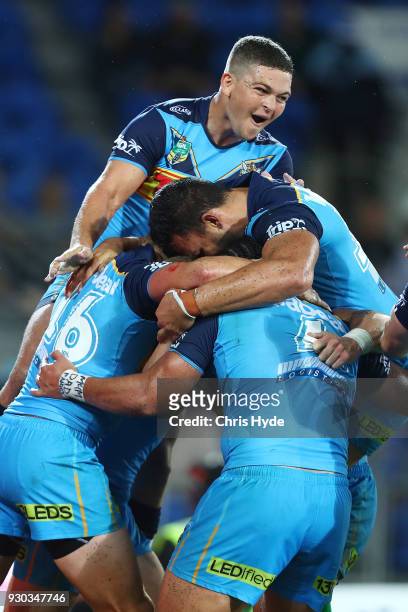 Ash Taylor celebrates after Konrad Hurrell of the Titans scores a try to win the round one NRL match between the Gold Coast Titans and the Canberra...