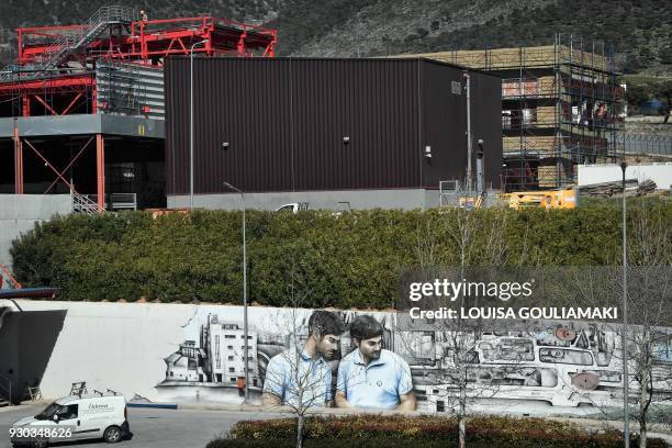 Workers work at the expanding facilities of the Papastratos tobbacco company in Aspropyrgos near Athens on March 8, 2018. Philip Morris...