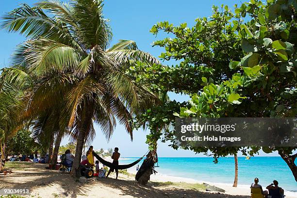 group of people on the beach, san juan, puerto rico - condado beach stock pictures, royalty-free photos & images