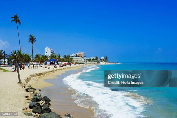 group of people enjoying on the beach, san juan, puerto rico - condado beach stock pictures, royalty-free photos & images