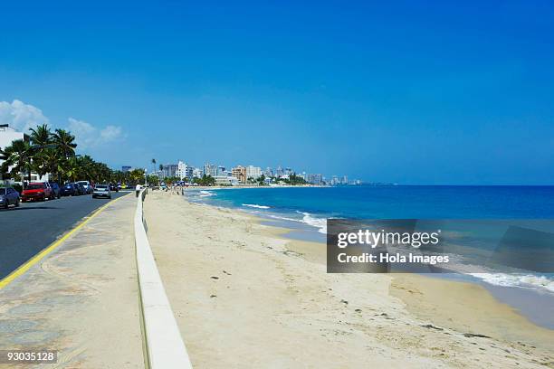road along the beach, san juan, puerto rico - condado beach stock pictures, royalty-free photos & images