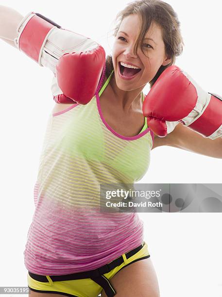 woman wearing boxing gloves and laughing - boxing womens stock pictures, royalty-free photos & images