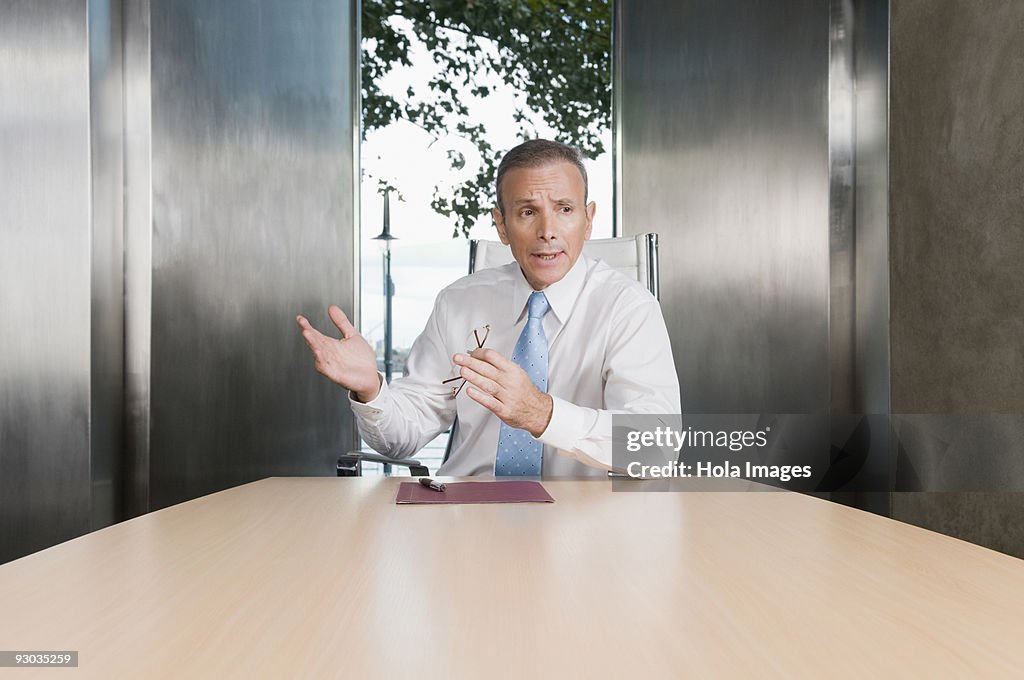 Businessman giving a presentation in a board room