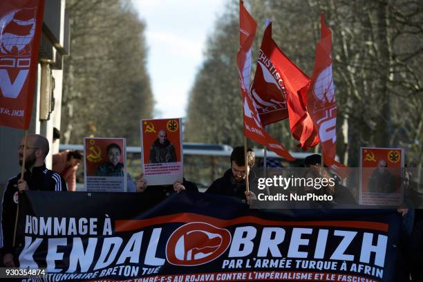 The banner reads 'Tribute to Kendal Breizh revolutionary Breton killed by Turkish Army in Afrin'. Kurds demonstrate to pay tribute to French fighter...