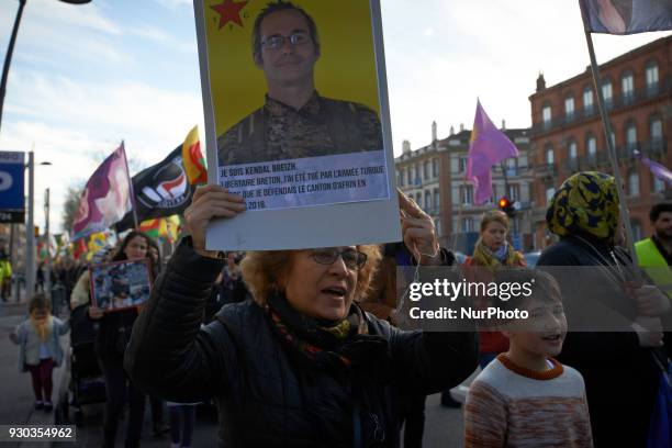 Kurd woman shows a placard depicting French fighter Kendal Breizh. Kurds demonstrate to pay tribute to French fighter Kendal Breizh killed by turkish...