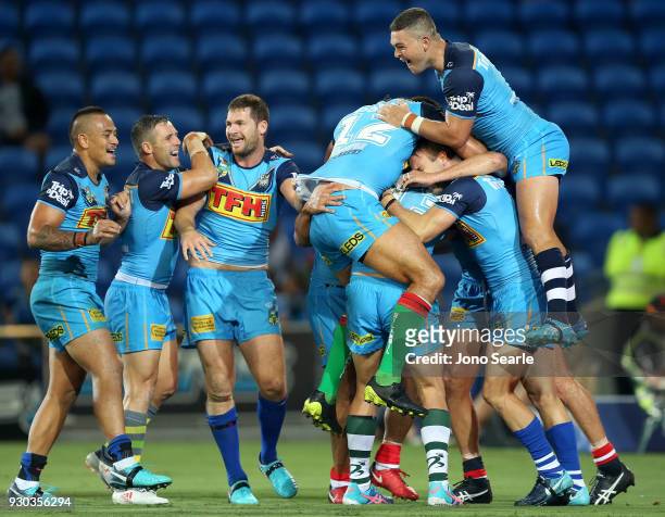 Ashley Taylor of the Titans celebrates the winning try with his team during the round one NRL match between the Gold Coast Titans and the Canberra...