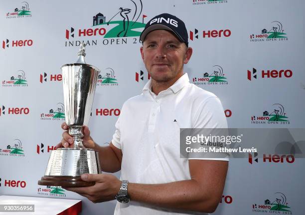 Matt Wallace of England celebrates with the trophy after winning the play off during day four of The Hero Indian Open at Dlf Golf and Country Club on...