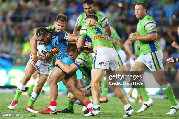 Konrad Hurrell of the Titans is tackled during the round one NRL match between the Gold Coast Titans and the Canberra Raiders at Cbus Super Stadium...