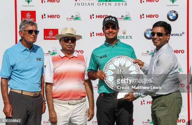 Shubhankar Sharma of India is presented with an award for the most promising Indian golfer by Director of The European Tour David Williams and...