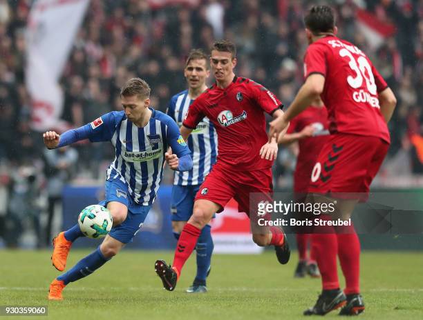 Mitchell Weiser of Hertha BSC is challenged by Janik Haberer of SC Freiburg during the Bundesliga match between Hertha BSC and Sport-Club Freiburg at...