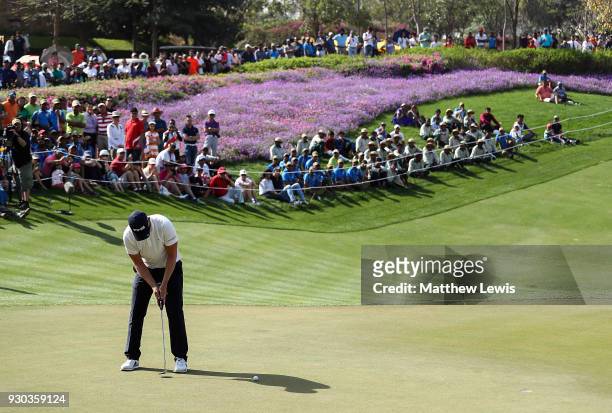Matt Wallace of England hits the winning putt on the 18th hole during a play off against Andrew Johnson of England on day four of The Hero Indian...