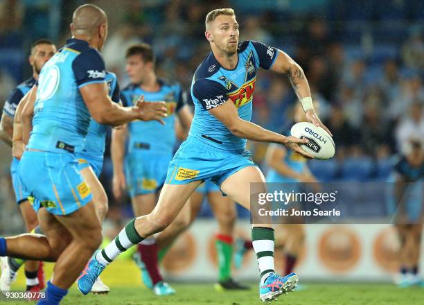 Bryce Cartwright makes a pass during the round one NRL match between the Gold Coast Titans and the Canberra Raiders at Cbus Super Stadium on March...
