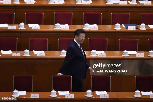 China's President Xi Jinping arrives for the third plenary session of the first session of the 13th National People's Congress at the Great Hall of...