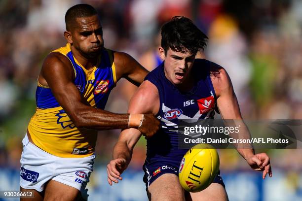 Andrew Brayshaw of the Dockers is tackled by Lewis Jetta of the Eagles during the AFL 2018 JLT Community Series match between the Fremantle Dockers...